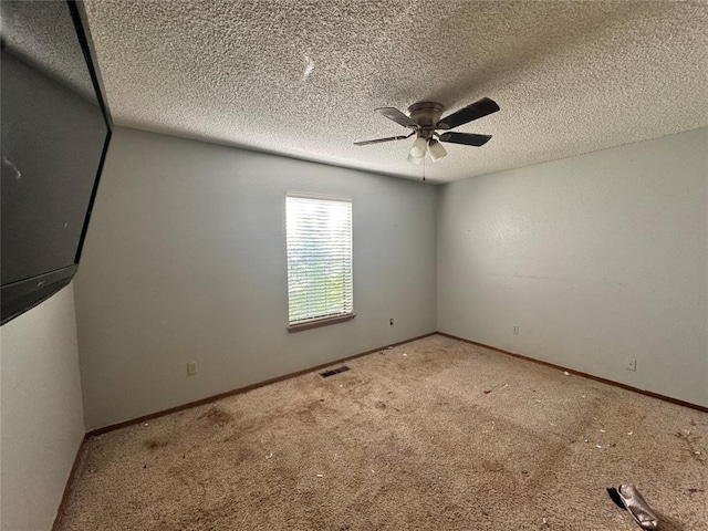 100 N Rockypoint Dr, Edmond, OK 73003 - carpeted empty room with ceiling fan and a textured ceiling