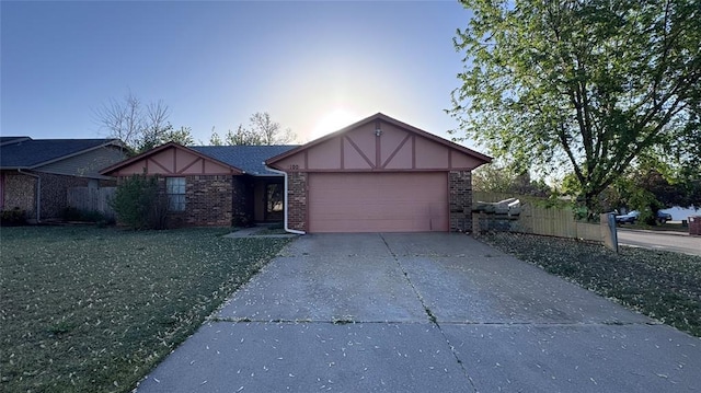 100 N Rockypoint Dr, Edmond, OK 73003 - english style home featuring a garage, driveway, and brick siding