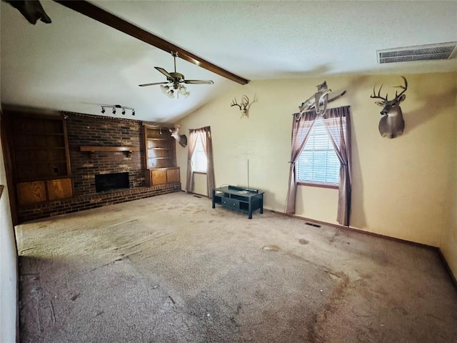 100 N Rockypoint Dr, Edmond, OK 73003 - unfurnished living room featuring carpet floors, a ceiling fan, and a brick fireplace