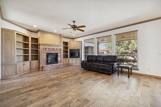 1240 Penny Ln, El Reno, OK 73036 - living room with a fireplace, crown molding, ceiling fan, baseboards, and light wood-style floors