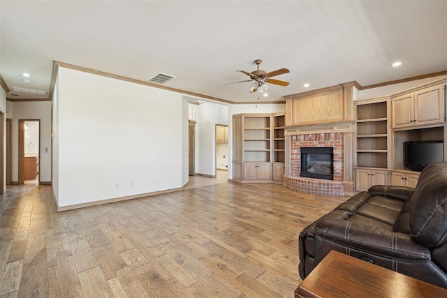 1240 Penny Ln, El Reno, OK 73036 - living room featuring ceiling fan, ornamental molding, light wood-style flooring, and visible vents