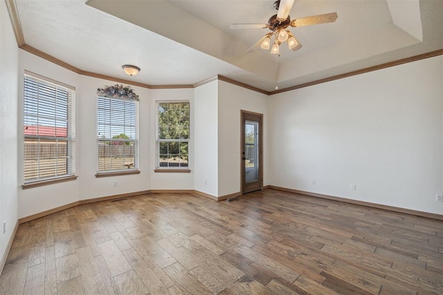 1240 Penny Ln, El Reno, OK 73036 - empty room with a tray ceiling, baseboards, a ceiling fan, and wood finished floors
