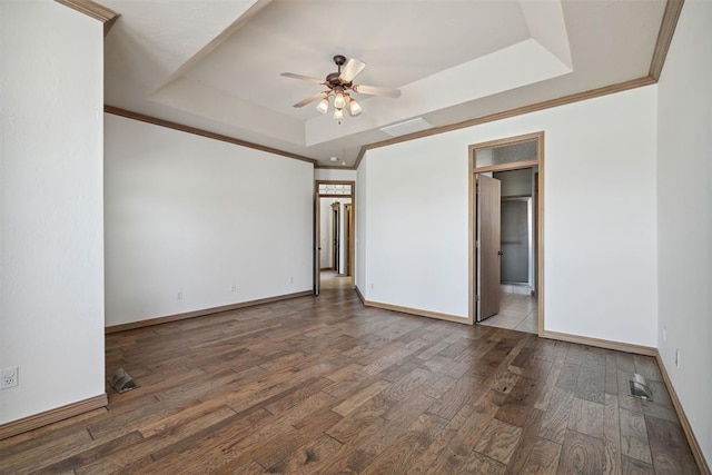1240 Penny Ln, El Reno, OK 73036 - unfurnished bedroom featuring connected bathroom, wood finished floors, a tray ceiling, crown molding, and baseboards