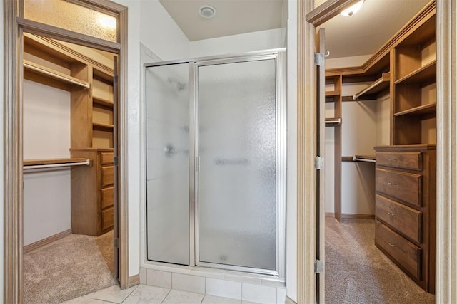 1240 Penny Ln, El Reno, OK 73036 - bathroom featuring a stall shower, baseboards, and a walk in closet