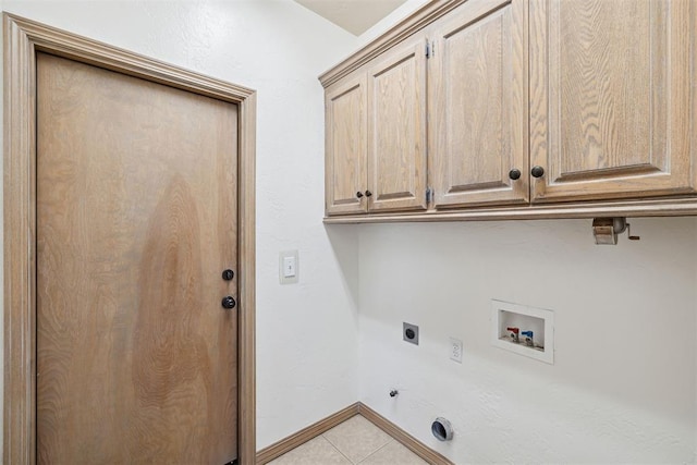 1240 Penny Ln, El Reno, OK 73036 - clothes washing area featuring cabinet space, hookup for an electric dryer, gas dryer hookup, light tile patterned floors, and hookup for a washing machine