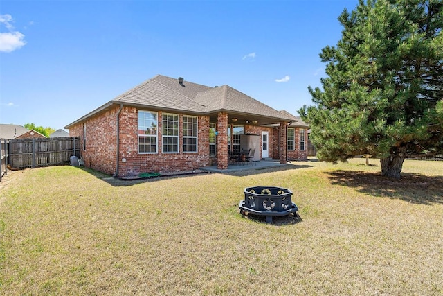 1240 Penny Ln, El Reno, OK 73036 - rear view of property with a yard, brick siding, and a fenced backyard