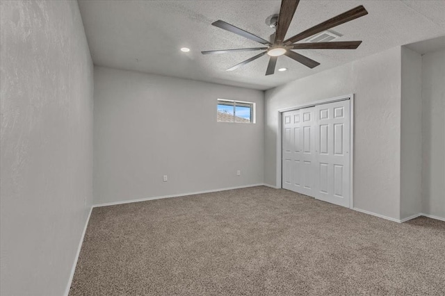 unfurnished bedroom with a closet, ceiling fan, carpet, a textured ceiling, and recessed lighting