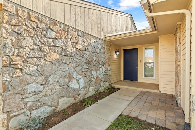 entrance to property with stone siding