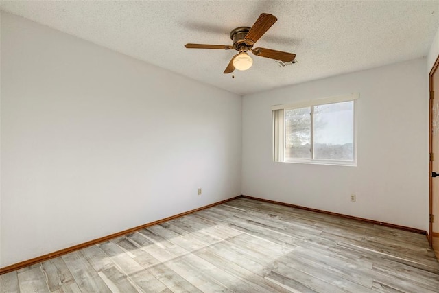 unfurnished room with light wood finished floors, visible vents, a textured ceiling, and ceiling fan