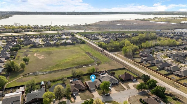 drone / aerial view featuring a water view and a residential view