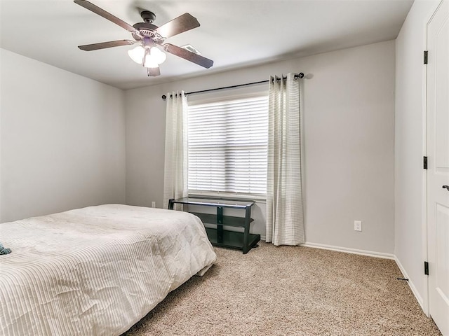 carpeted bedroom featuring visible vents, ceiling fan, and baseboards