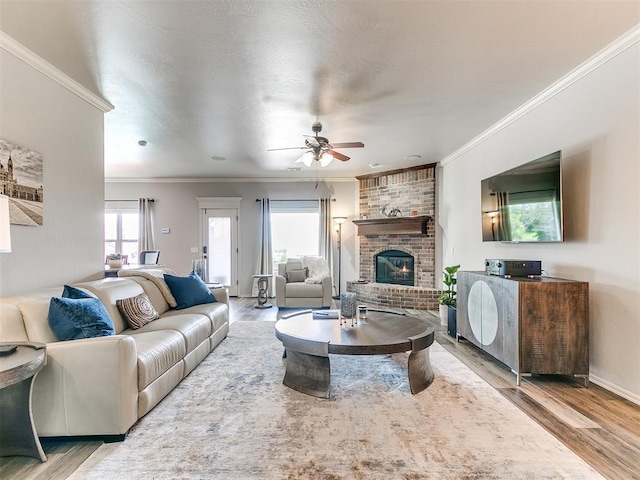 living area with a fireplace, wood finished floors, and ceiling fan