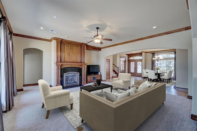 11016 Katie Beth Ln, Oklahoma City, OK 73170 - living area with arched walkways, a fireplace, ornamental molding, stairs, and baseboards