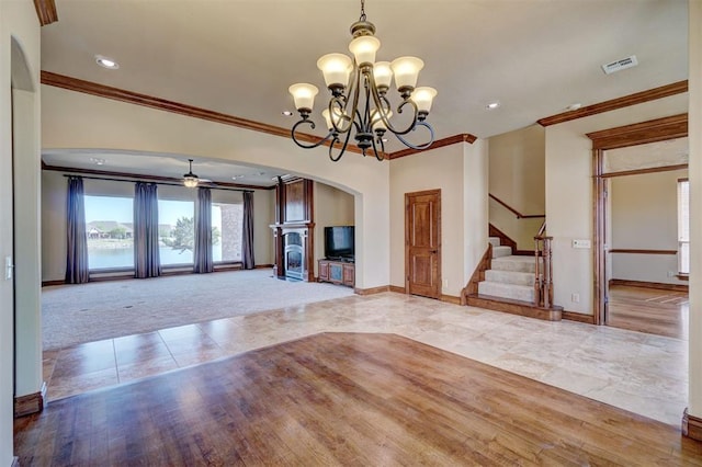 11016 Katie Beth Ln, Oklahoma City, OK 73170 - unfurnished living room with crown molding, baseboards, arched walkways, stairway, and tile patterned flooring