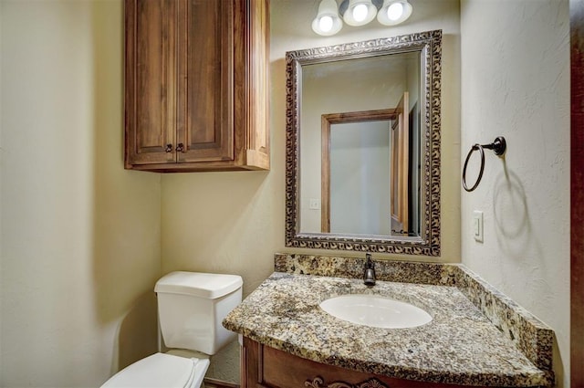 11016 Katie Beth Ln, Oklahoma City, OK 73170 - half bathroom with toilet, vanity, and a textured wall