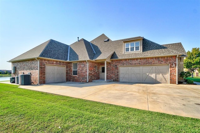 11016 Katie Beth Ln, Oklahoma City, OK 73170 - view of front facade featuring an attached garage, roof with shingles, driveway, and central air condition unit