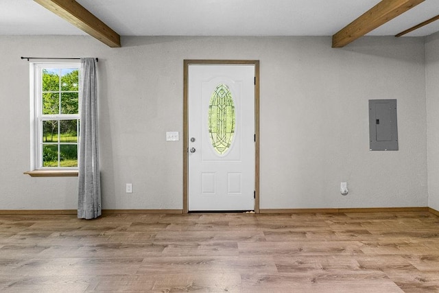 foyer featuring beamed ceiling, light wood-style flooring, and electric panel