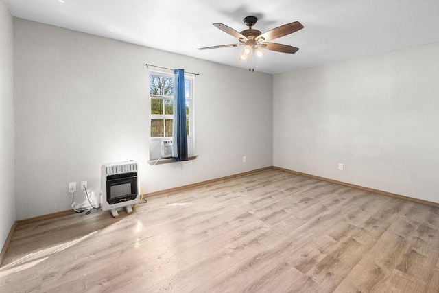 unfurnished living room with baseboards, cooling unit, heating unit, ceiling fan, and wood finished floors