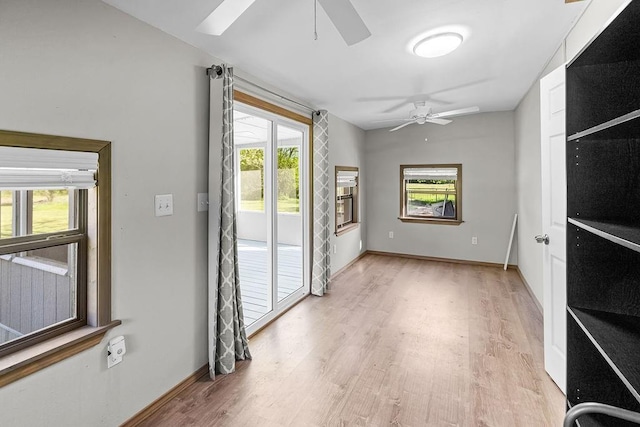 interior space with ceiling fan, light wood-type flooring, and baseboards