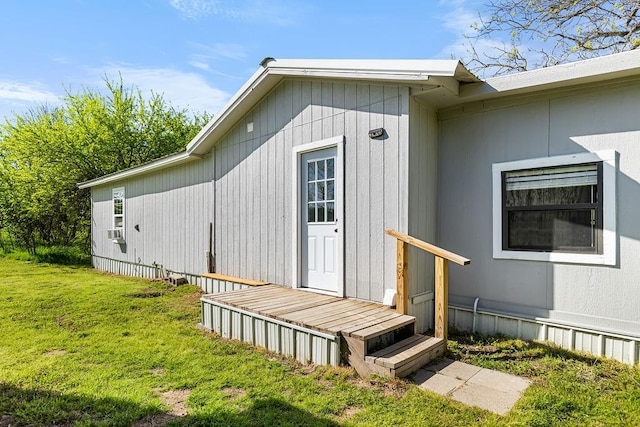 view of exterior entry featuring a yard