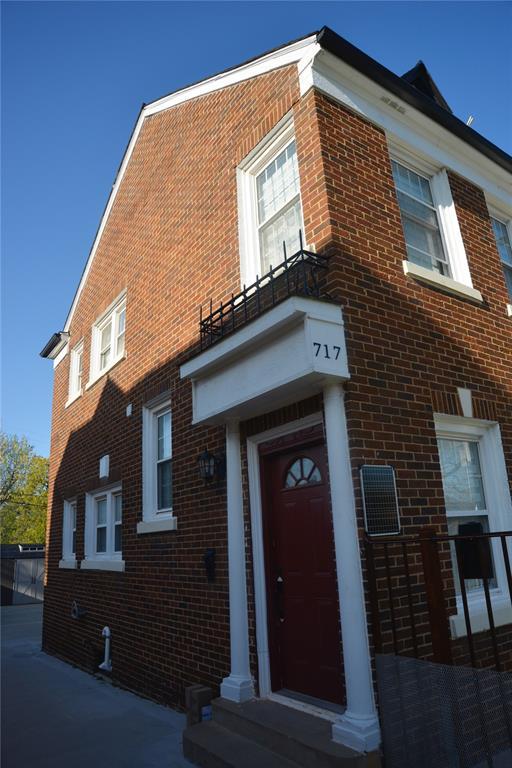 exterior space featuring brick siding and a balcony