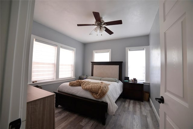bedroom with baseboards, ceiling fan, and wood finished floors