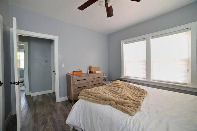 bedroom featuring baseboards, multiple windows, a ceiling fan, and dark wood-style flooring