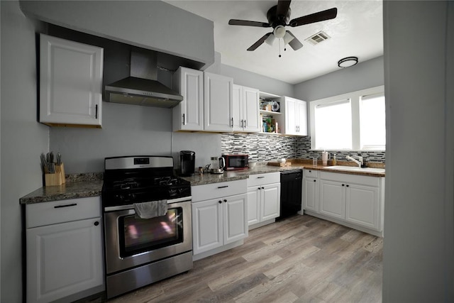 kitchen featuring visible vents, stainless steel gas range, wall chimney exhaust hood, a sink, and dishwasher