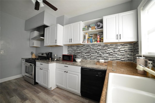 kitchen with a sink, wall chimney exhaust hood, a ceiling fan, light wood-type flooring, and black appliances
