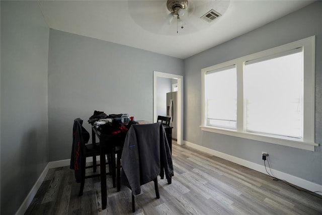 dining room with visible vents, baseboards, ceiling fan, and wood finished floors