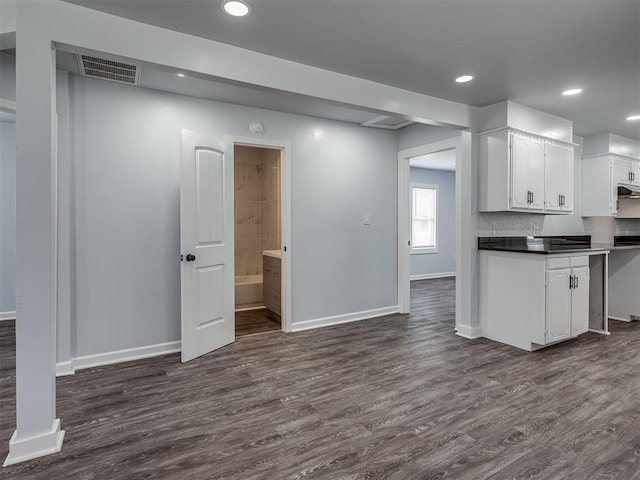 kitchen featuring baseboards, dark wood-style floors, and visible vents