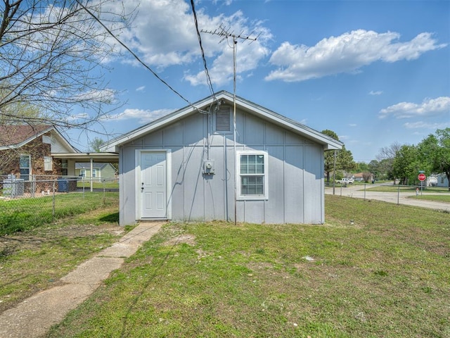 view of outbuilding featuring fence
