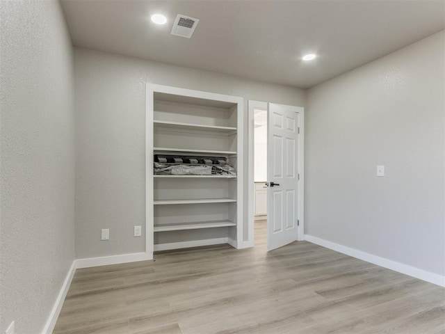 unfurnished bedroom with light wood-style floors, baseboards, visible vents, and recessed lighting