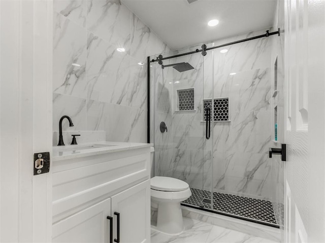 full bathroom with vanity, toilet, marble finish floor, tile walls, and a marble finish shower