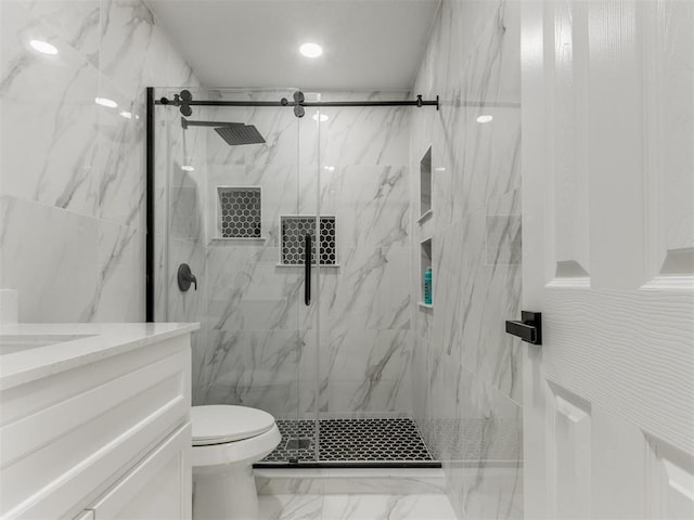 bathroom featuring a marble finish shower, toilet, marble finish floor, and vanity