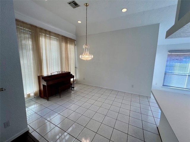 dining area with a chandelier, light tile patterned floors, visible vents, and a healthy amount of sunlight