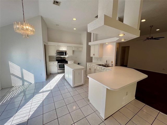 kitchen with high vaulted ceiling, visible vents, light countertops, a sink, and stainless steel appliances