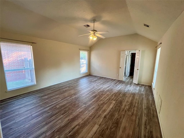 interior space featuring visible vents, ceiling fan, lofted ceiling, and dark wood-style floors