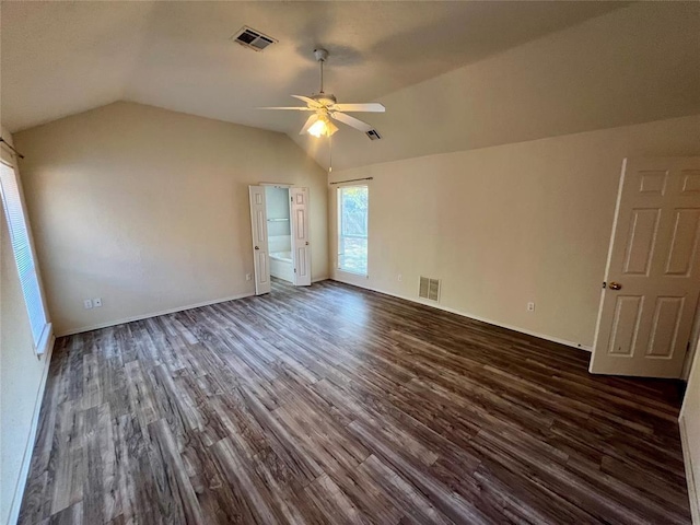 unfurnished bedroom featuring dark wood-style floors, visible vents, and lofted ceiling