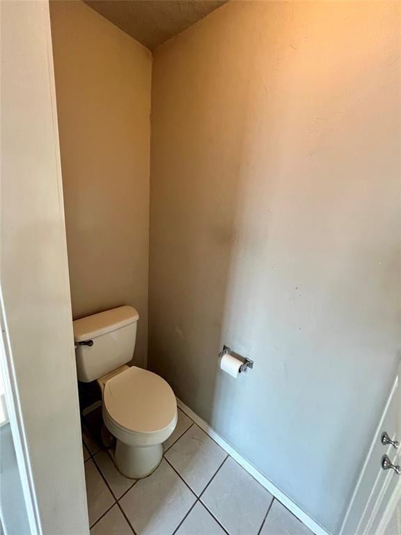 bathroom featuring tile patterned floors and toilet