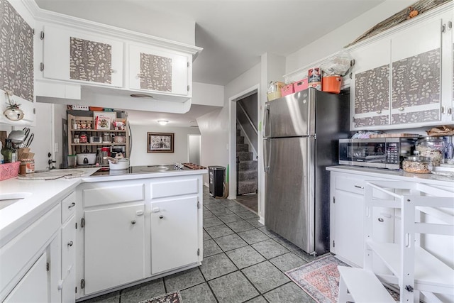 2428 SW 79th St, Oklahoma City, OK 73159 - kitchen with white cabinets, appliances with stainless steel finishes, and light tile patterned floors