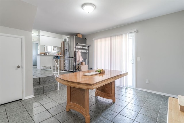2428 SW 79th St, Oklahoma City, OK 73159 - interior space with light tile patterned flooring, stainless steel fridge, and baseboards