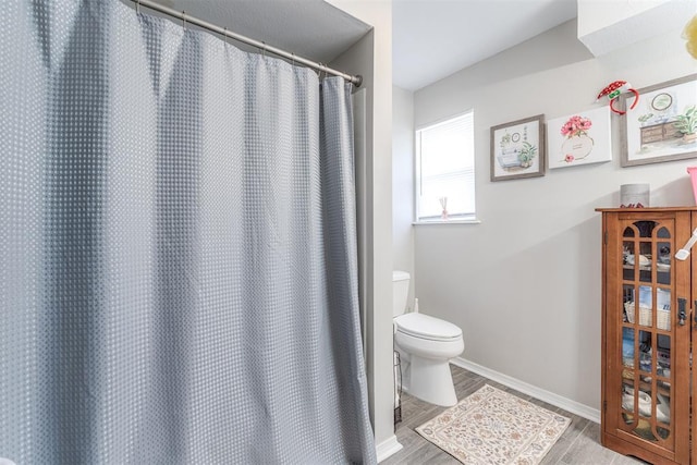 2428 SW 79th St, Oklahoma City, OK 73159 - bathroom featuring toilet, a shower with curtain, wood finished floors, and baseboards