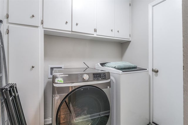 2428 SW 79th St, Oklahoma City, OK 73159 - clothes washing area with cabinet space and separate washer and dryer