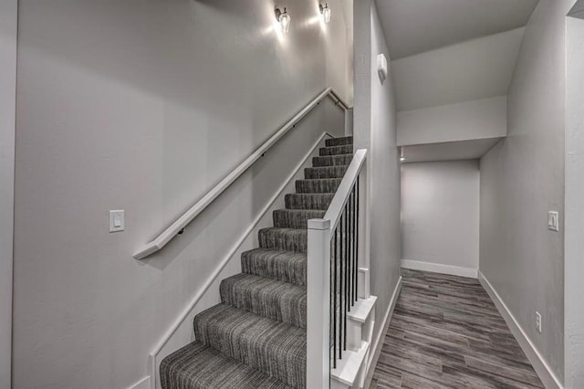 stairway with baseboards and wood finished floors