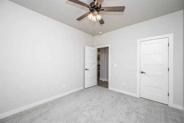 unfurnished bedroom with ceiling fan, baseboards, and carpet