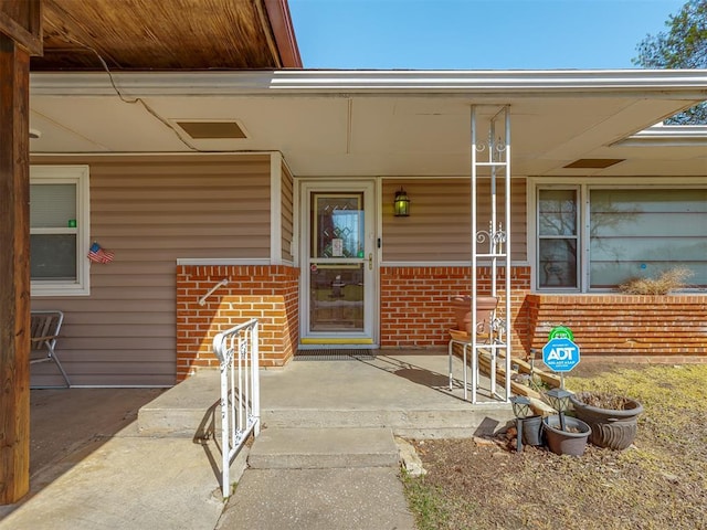209 S 2nd Ave, Stroud, OK 74079 - view of exterior entry with brick siding and covered porch