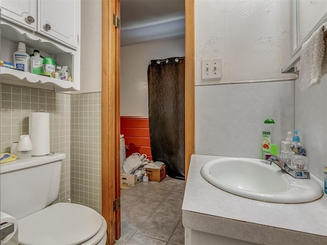 209 S 2nd Ave, Stroud, OK 74079 - bathroom with tile patterned floors, tile walls, and toilet