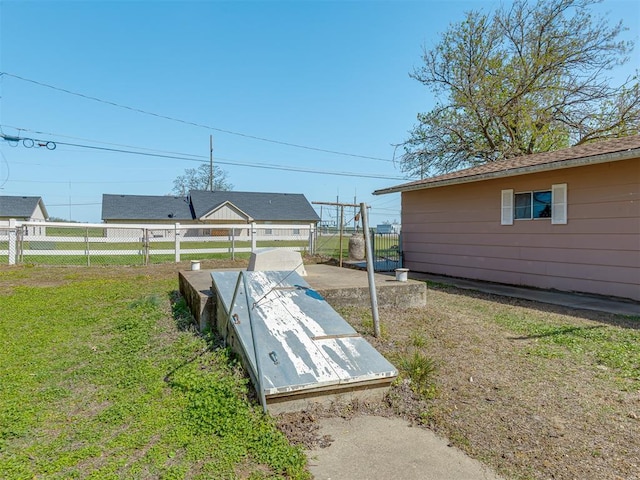 209 S 2nd Ave, Stroud, OK 74079 - view of storm shelter with fence and a lawn