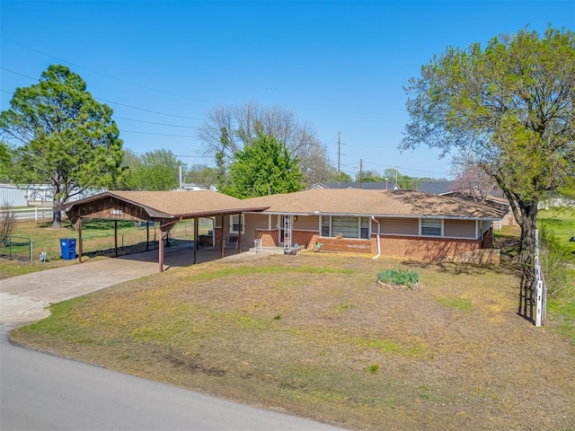 209 S 2nd Ave, Stroud, OK 74079 - ranch-style house with concrete driveway, a carport, and a front yard